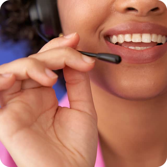 Professional call center agent smiling and engaging with clients.