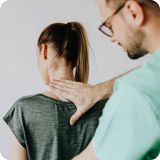 chiropractor adjusting a patient's neck