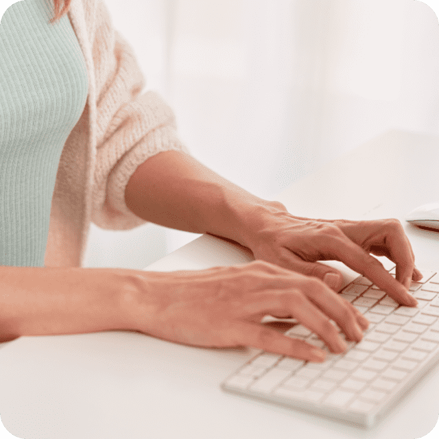 Person typing on keyboard