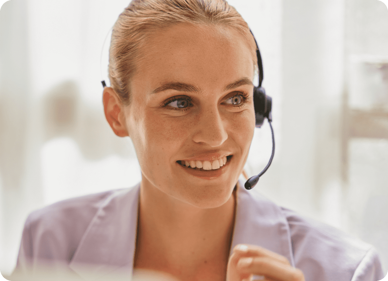 Receptionist with headphones smiling and looking away